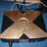 Modded original Xbox with gold paint, clear Xbox jewel and blue chasing lights.